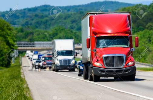 Red Semi Leads Traffic Down An Interstate Highway